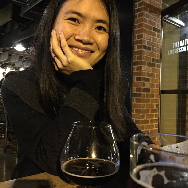 Photo: Hui Shen PhD, smiling at outdoor restaurant
